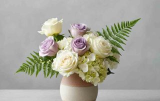 Sympathy arrangement of roses, ferns and hydrangea