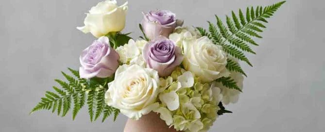 Sympathy arrangement of roses, ferns and hydrangea